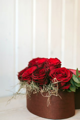 Romantic luxury red roses in a gift box with red ribbon.