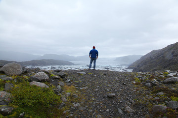 A lonely man looks and the Icelandic glacier