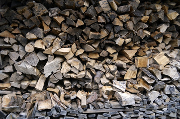 Detailed view to stacked and seasoned firewood for an open-hearth fireplace