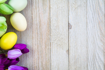 Spring and Easter background with tulips on wooden board, flat lay