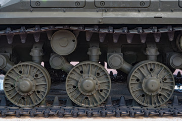 Fototapeta na wymiar Caterpillar of a military tank standing in a park.