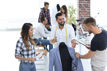 Fototapeta premium tailor and designers to discuss men's suit