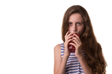 Portrait of a beautiful girl with a glass of juice on a white background.