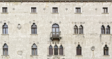 Obraz premium Main facade of the Palazzetto Veziano (Venetian palace), old historical building in Udine, Italy. Traditional Italian architecture