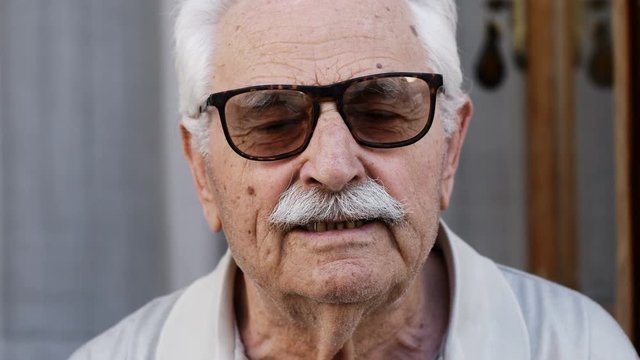 Portrait of senior man with sunglasses looking at camera