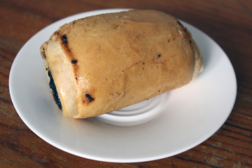 Bun. Bakery products. Bun with poppy seeds. Food on a wooden background