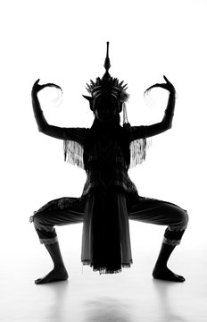 The lady in Southern thai classical dancing suit is posing on white background.