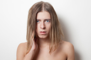 Naklejka premium Androgyny young man on white background. Close up