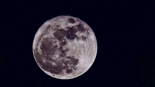 A full moon crosses the sky in a digital timelapse.