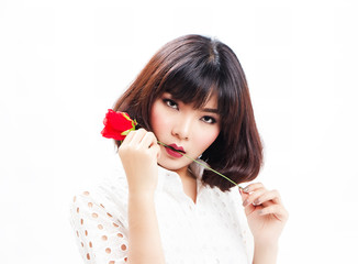 The lady is posing by put red rose in her lip.