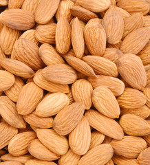 Pile of almonds close-up as background.