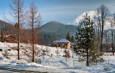 The house is set against the beautiful mountains on a Sunny winter morning