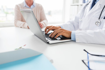 senior woman and doctor with laptop at hospital