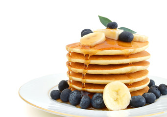 Stack of pancakes with fresh blueberry on white