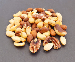 Mix nuts, dry fruits and chocolate on black background