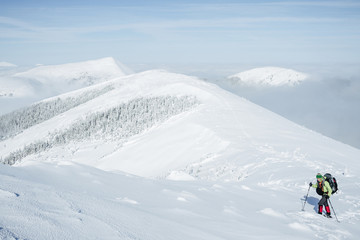 Fototapeta na wymiar Climber walking in snowy Gorgany mountains