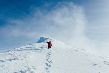 Footprints in snow behind climber in Gorgany mountains