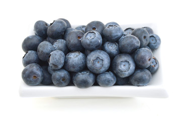 blue berry in white plate on white background