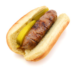 Grilled bratwurst on a bun isolated on white
