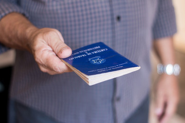 Man holding the Brazilian Work Portfolio by hand