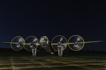 Fototapeta na wymiar Lancaster bomber with engines running at night
