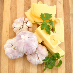 Garlic, cheese and Cilantro on wooden board
