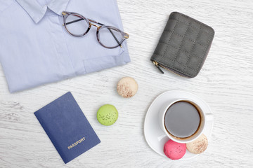 Passport, coffee mug, purse and shirt. Travel Concept