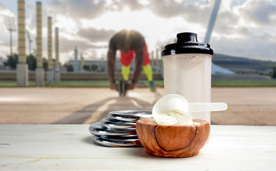 Protein shake Vanilla flavor accompanied by weights and sportsmen