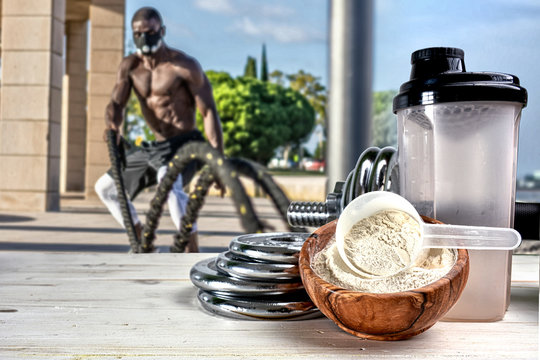 Protein shake Vanilla flavor accompanied by weights and sportsmen