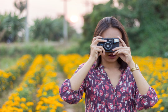 Women are taking photos with a camera.