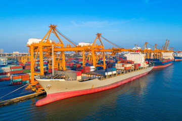 Containers yard in port congestion with ship vessels are loading and discharging operations of the...