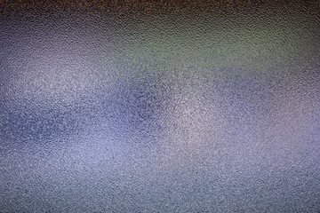 Frosted glass texture. Colorful lights background.
