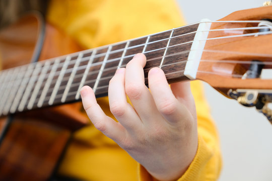 Girl playing acustic guitar