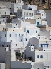 Fototapeta na wymiar Chora of Astypapaia island ,Greece at daytime a close up of the white houses with the colorful windows