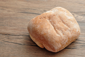 A golden brown bread on a wooden table