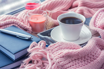 cup of coffee on a table in front of a window, the concept of breakfast and rest during work, a lifestyle of authentic, selective focus