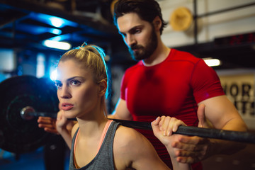 Close up of motivated focused attractive young blond fitness girl doing squads.