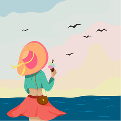 Girl in a hat on the ocean with ice cream