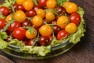 Cherry tomatoes in a glass plate close up