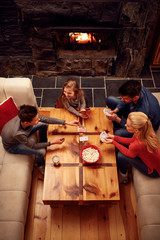 parents playing cards with kids top view