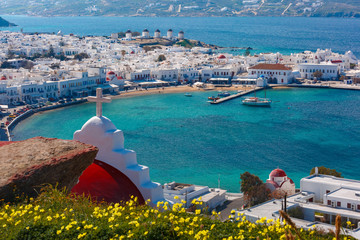 Aerial view of Mykonos City, Chora with Old Port, white houses, windmilles and churches on the island Mykonos, The island of the winds, Greece - obrazy, fototapety, plakaty