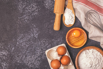 Ingredients for baking  - flour, wooden spoon, rolling pin, eggs
