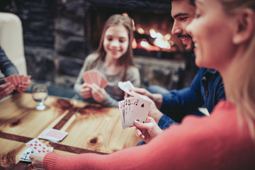 Young family playing card game