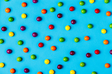 Colorful candies pattern on a blue background.