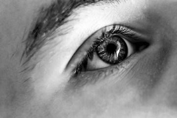 Texture, black and white, close-up of a beautiful eye of a Caucasian race boy.