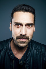 Young handsome man with beard and mustache studio portrait