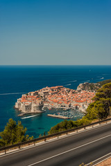 Spectacular picturesque view on the old town (medieval Ragusa) and Dalmatian Coast of Adriatic Sea. Picture taken from the mountain trails above Dubrovnik citadel, Famous European Travel Destination.