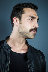 Fototapeta premium Young handsome man with beard and mustache studio portrait