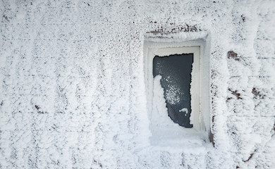 frozen window of house in winter scene