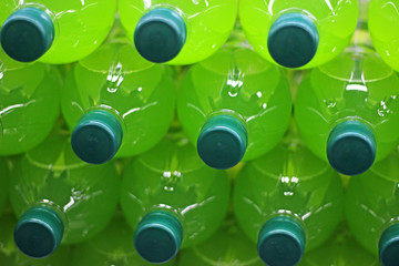 stack of lying bottles with green lemonade